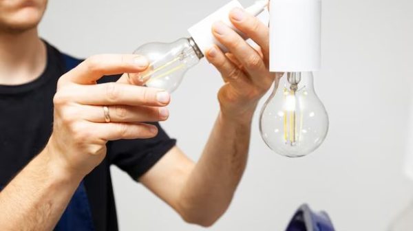 How do you replace a light bulb under a cabinet?