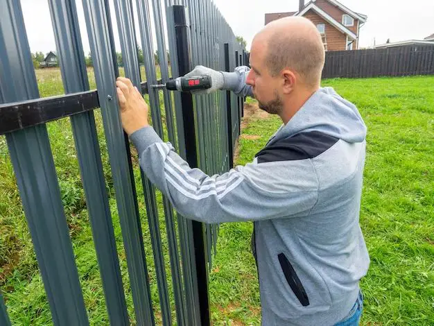 How do you fix the top of a metal fence