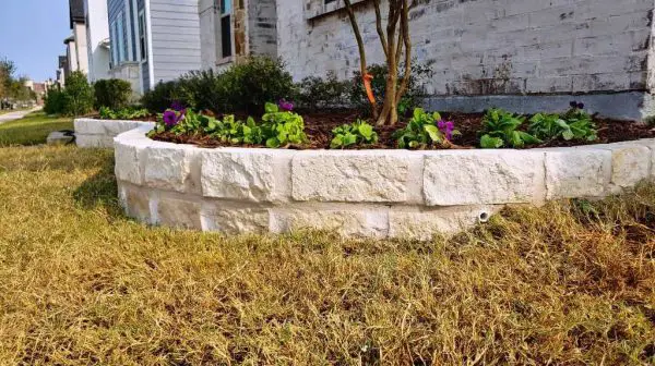 How do you make a stacked stone flower bed border?