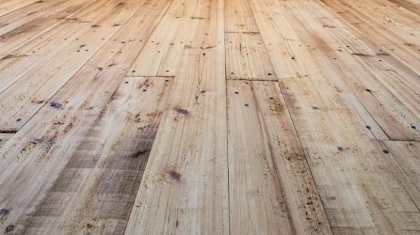 How do you prepare reclaimed wood for flooring?