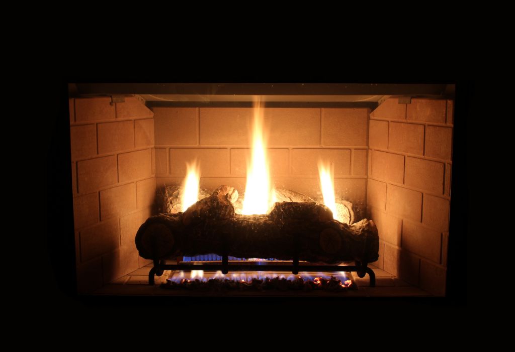 How do I light the pilot on my gas fireplace