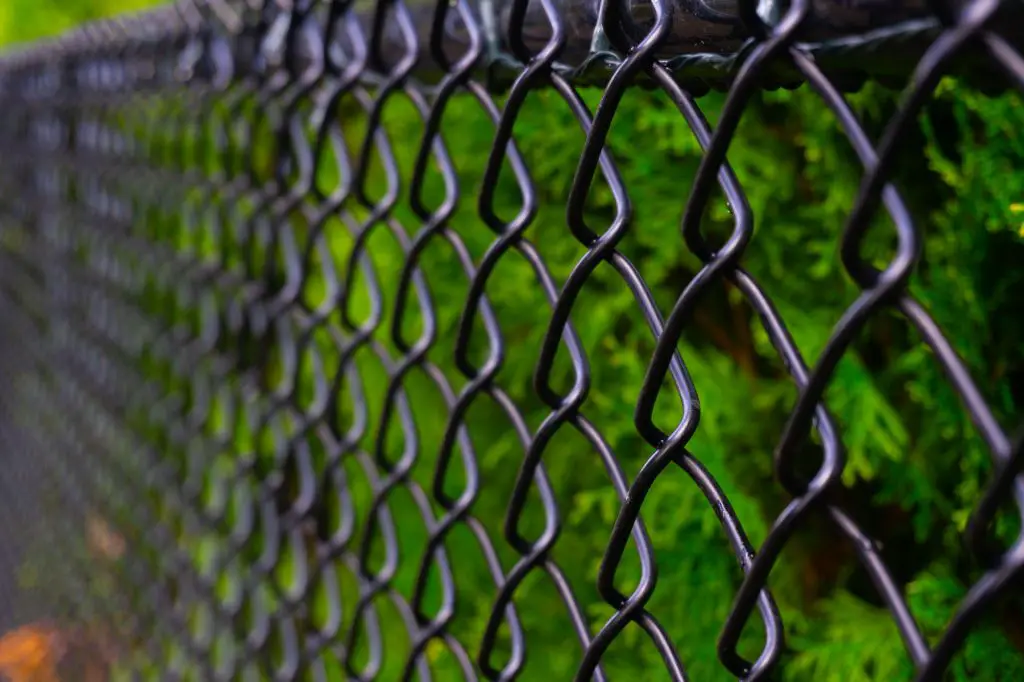 How do you repair a hole in a chain link fence