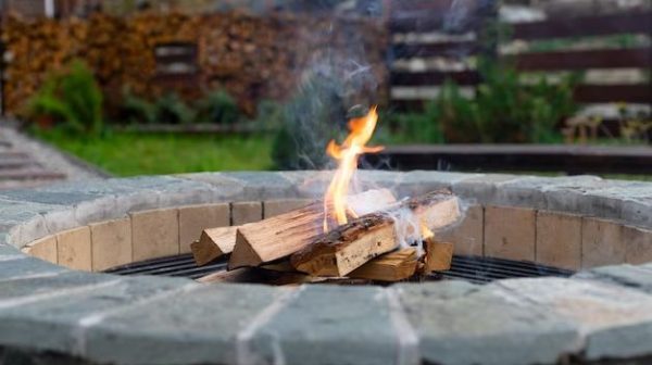 Should you remove ash from fire pit?