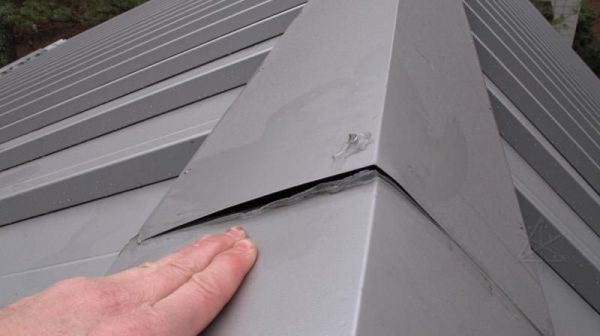 How much should a metal ridge cap overlap?