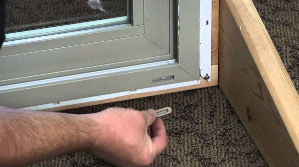 How do you clean a weep hole in a sliding glass door?