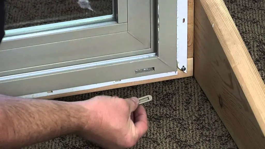 How do you clean a weep hole in a sliding glass door