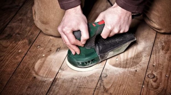 How do you sand with a hand sander?