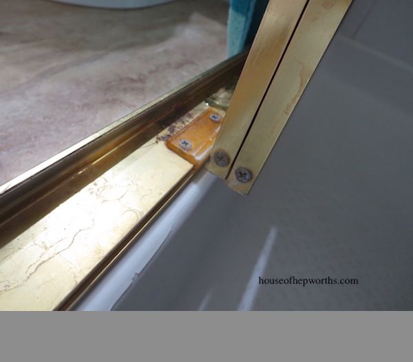 How do you fix a sliding shower door guide