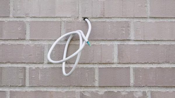 How do you seal a wire through an exterior wall?