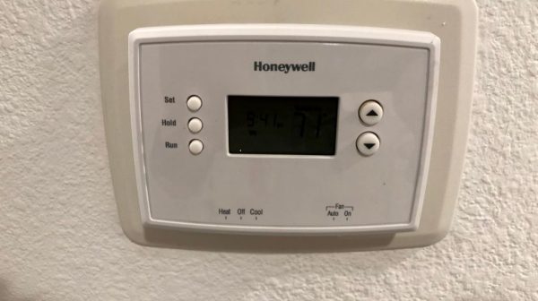 How do you remove a Honeywell thermostat from the wall plate?