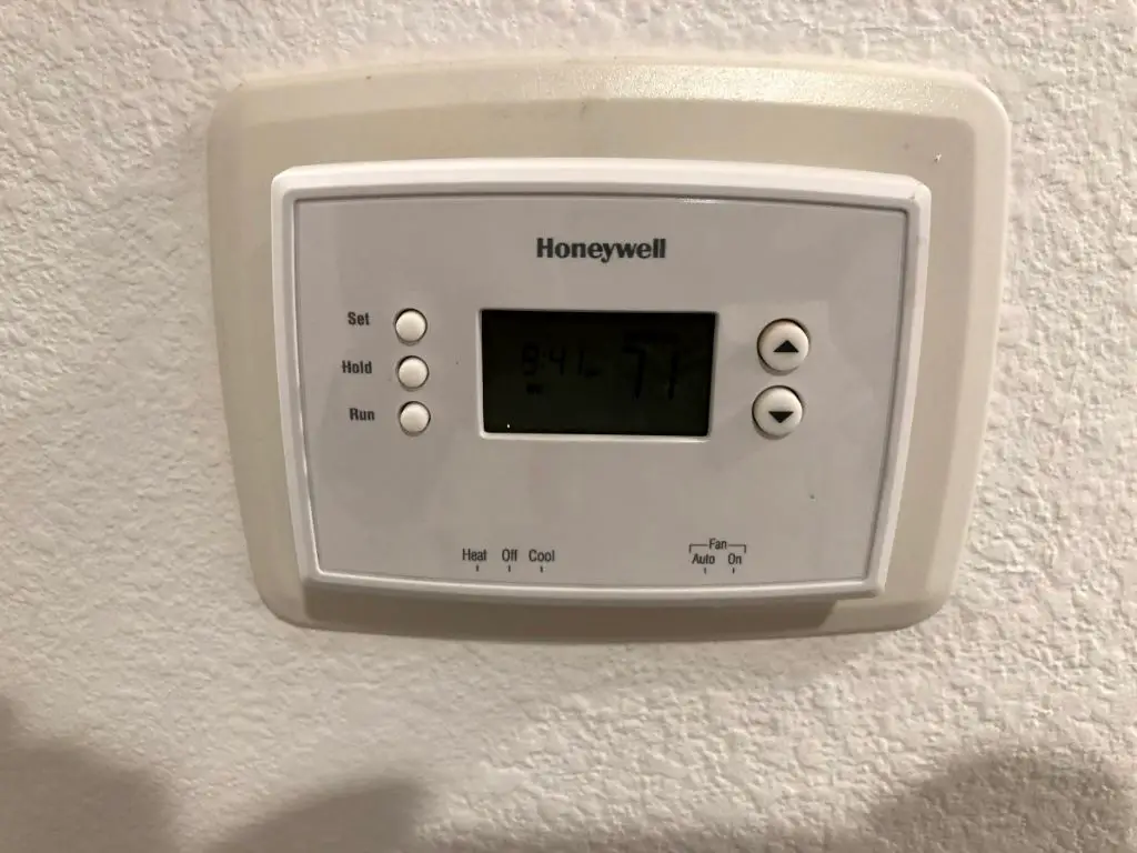 How do you remove a Honeywell thermostat from the wall plate