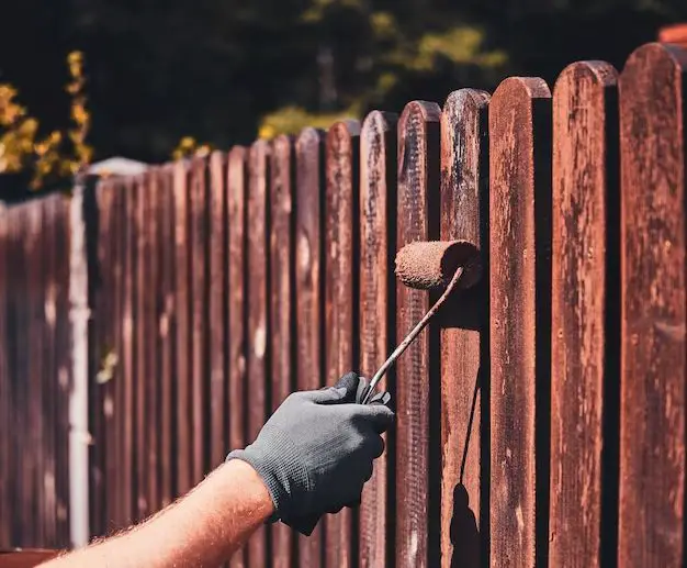 How do you stain a fence with a paint roller