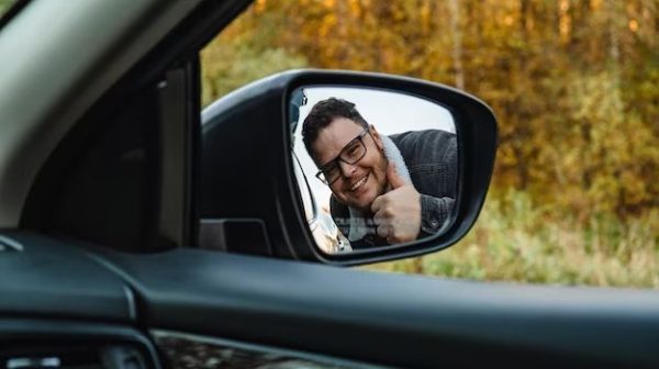 How do you stick a side mirror back on a car?