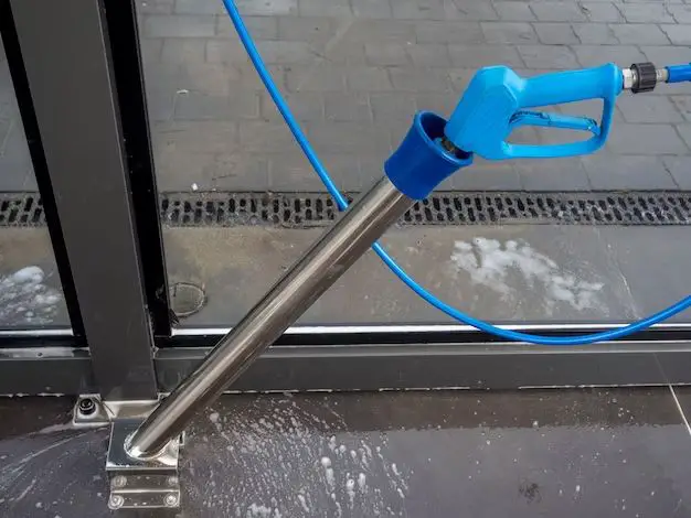 How do you put a soap nozzle on a pressure washer