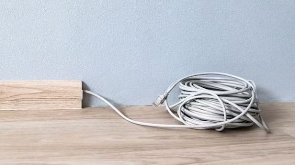 How do you run cables along baseboards?