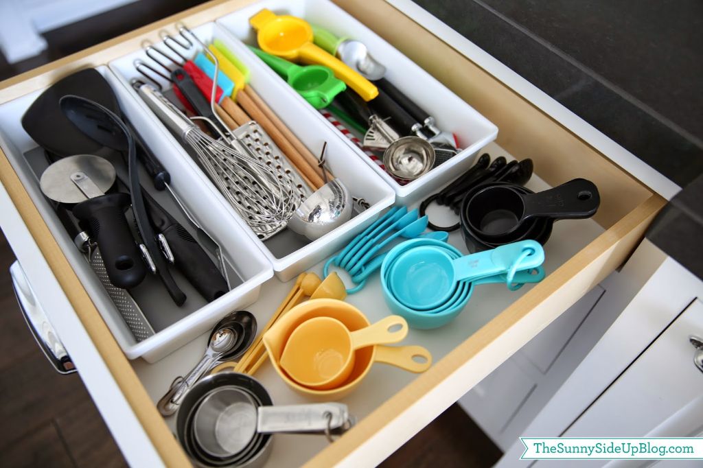 How do you organize measuring cups and spoons in a drawer