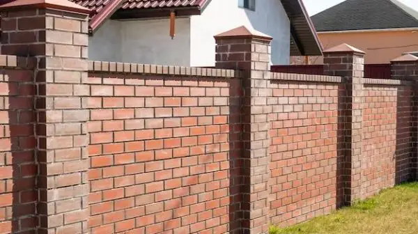 Is it cheaper to build a brick wall or fence?