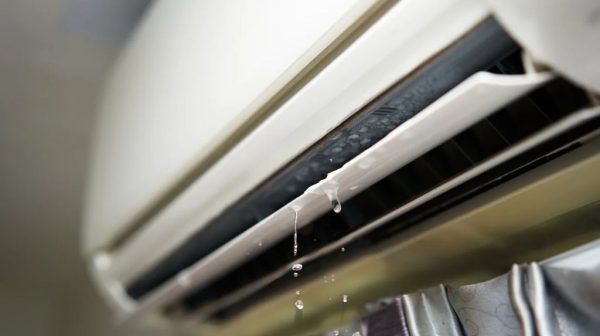 How do I stop my window air conditioner from spitting up water?