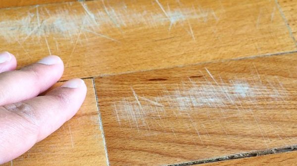 Can scratches in engineered hardwood be repaired?