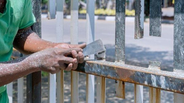 Do I need to sand a metal fence before painting?