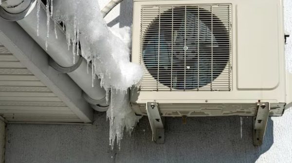 How do I protect my outdoor air conditioner in the winter?